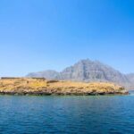 View of Kumzar and Telegraph Island in Oman with turquoise sea and rocky fjords