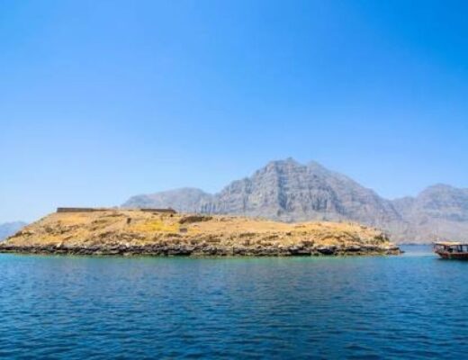 View of Kumzar and Telegraph Island in Oman with turquoise sea and rocky fjords