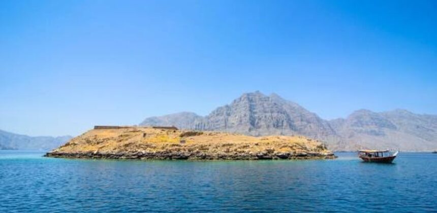 View of Kumzar and Telegraph Island in Oman with turquoise sea and rocky fjords